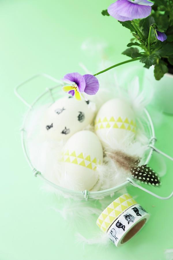 Easter Arrangement; Eggs Decorated With Washi Tape And Feathers In Basket Photograph by Syl Loves