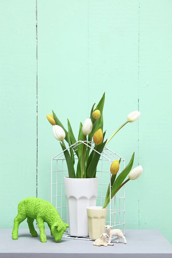 Easter Arrangement In Pastel Shades; Tulips In Beakers And Lamb Ornament Photograph by Thordis Rggeberg