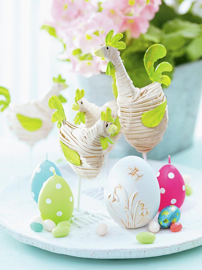 Easter Decoration - Fabric Hens, Egg-shaped Candles And Chocolate Eggs On White Platter Photograph by Biglife