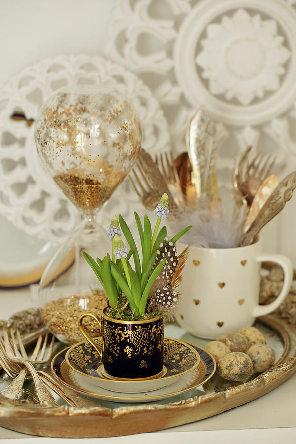 Easter Decoration With Grape Hyacinths In A Mug On A Tray With Silver Cutlery, Easter Eggs, And An Hourglass Photograph by Angelica Linnhoff