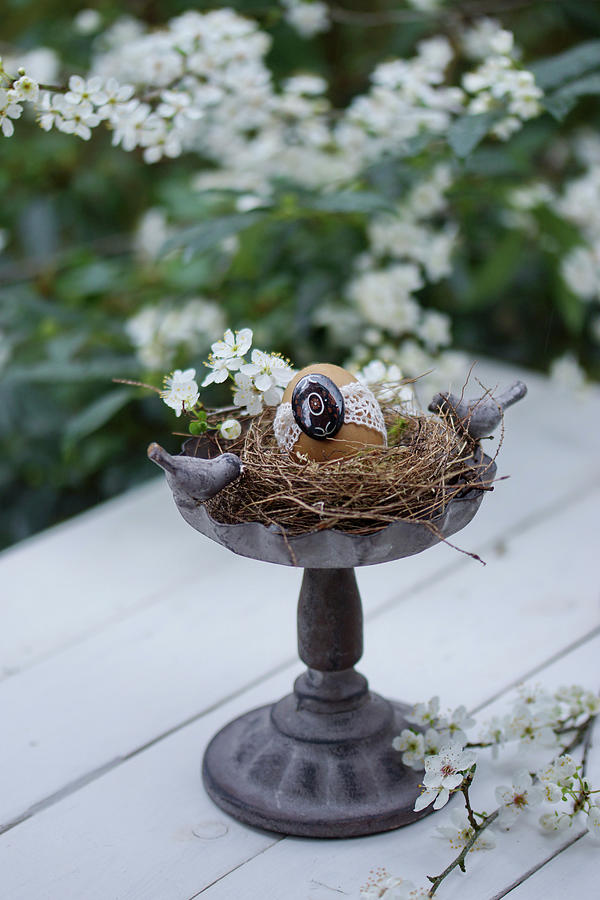 Easter Egg In Easter Nest In Birdbath Decorating Table Photograph by Angelica Linnhoff