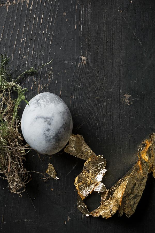 Easter Egg Painted With Stone Effect And Gold Leaf On Black-painted Wood Photograph by Pia Simon