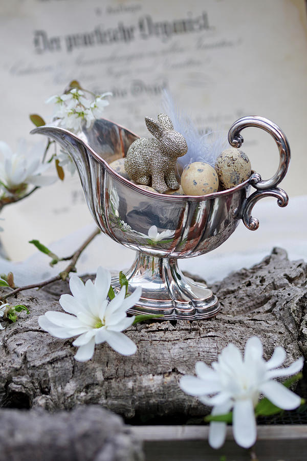 Easter Eggs And Bunny In Silver Sauce Boat, Magnolia And Serviceberry Flowers Photograph by Angelica Linnhoff