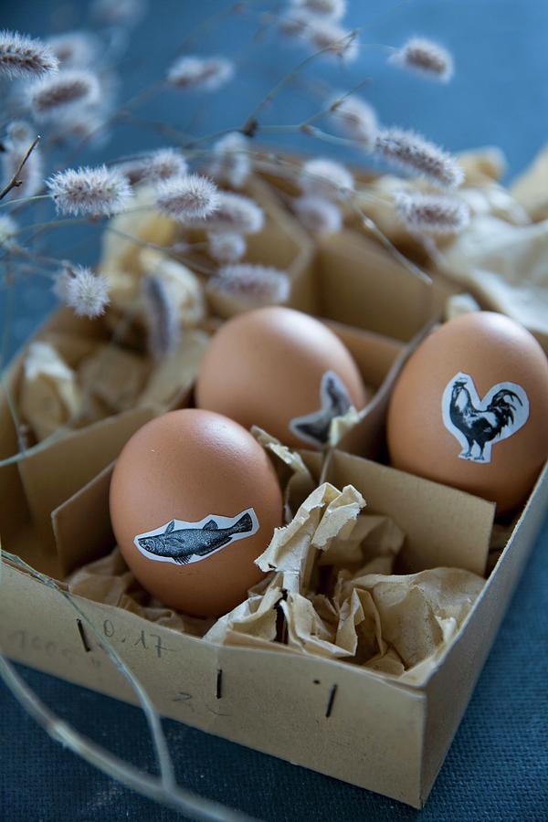 Easter Eggs Decorated With Animal Stickers In Vintage Cardboard Box Photograph by Alicja Koll