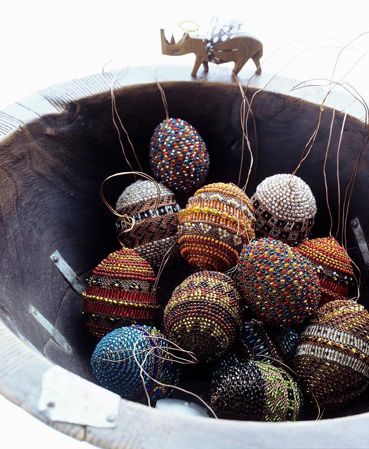 Easter Eggs Decorated With Beads In Rustic Bowl With Rhino Figurine On Rim Photograph by Matteo Manduzio