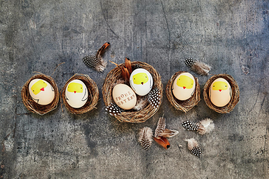 Easter Eggs Decorated With Chick Motifs In Small Baskets Photograph by Brigitte Sporrer