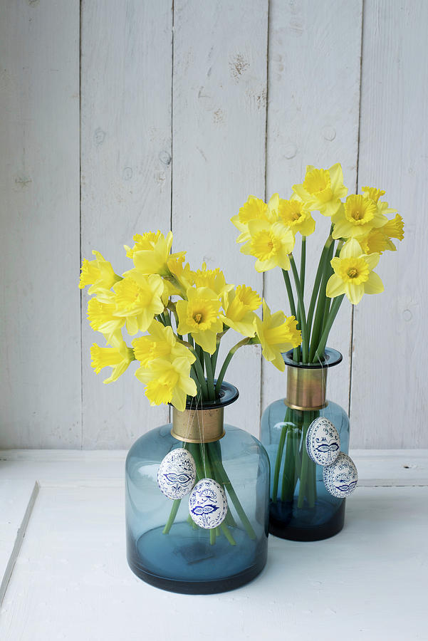 Easter Eggs Hung From Daffodils In Blue Bottles Photograph by Patsy&christian