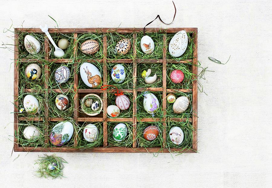 Easter Eggs In A Seedling Tray Lined With Grass Photograph by Jalag / Christine Bauer