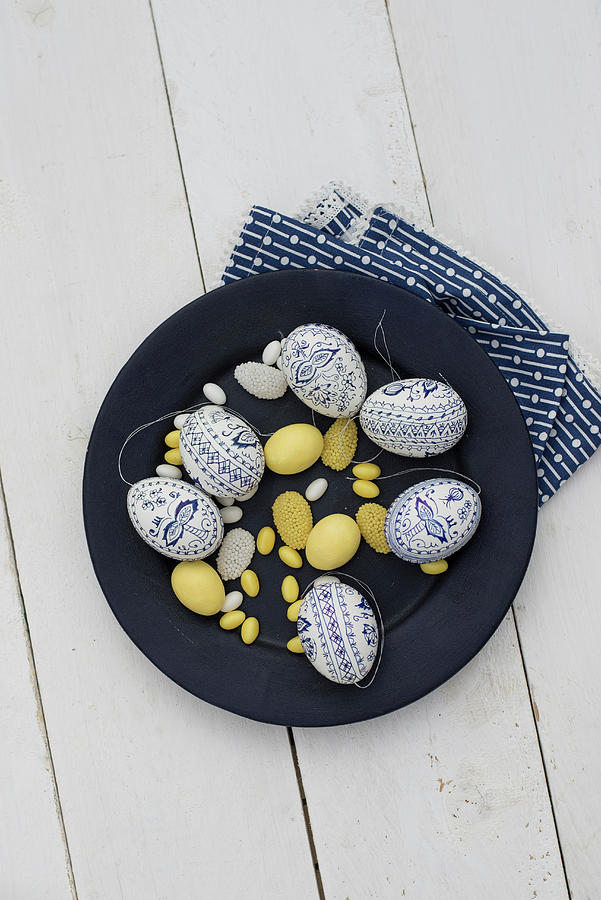 Easter Eggs Painted Blue And White, Yellow Sugar Eggs And Marzipan Eggs On Plate Photograph by Patsy&christian