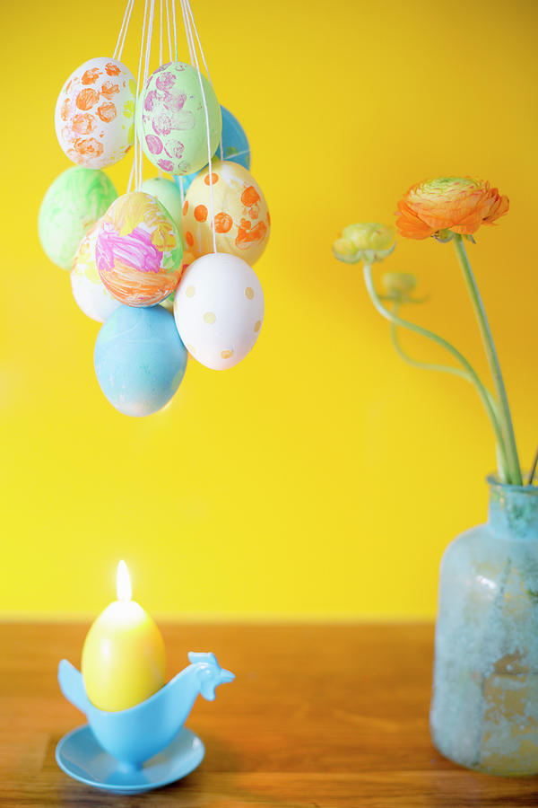 Easter Eggs Painted With Gouache Paint, Candle And Vase Of Flowers Photograph by Iris Wolf