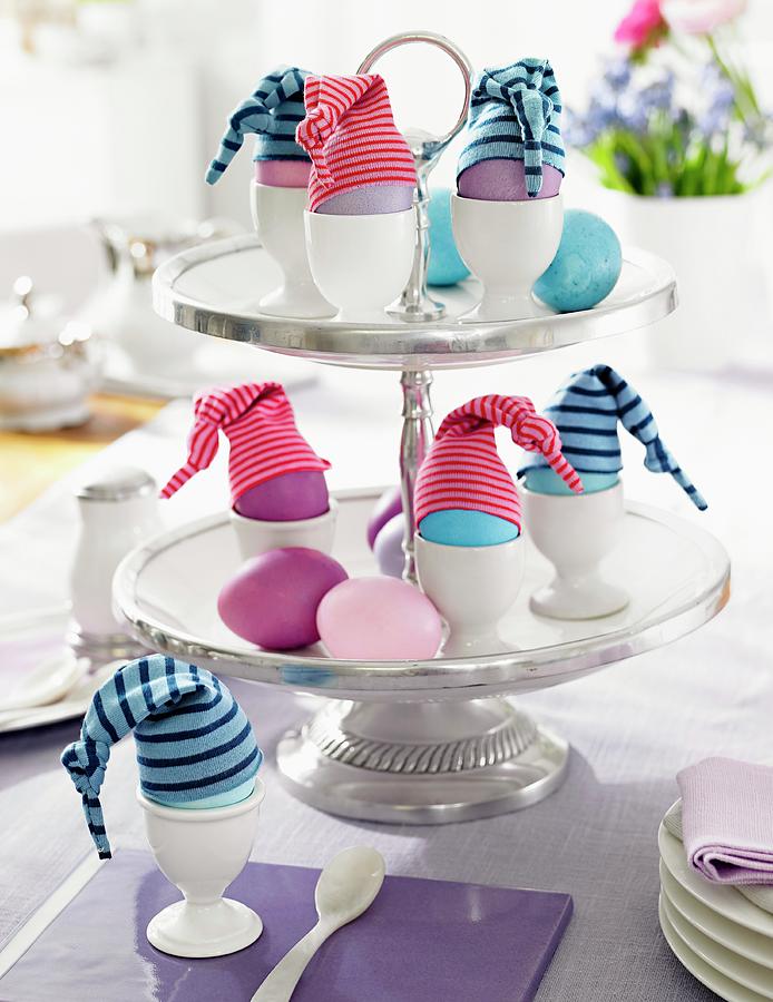 Easter Eggs With Little Hats On A Cake Stand Photograph by Jalag / Olaf Szczepaniak