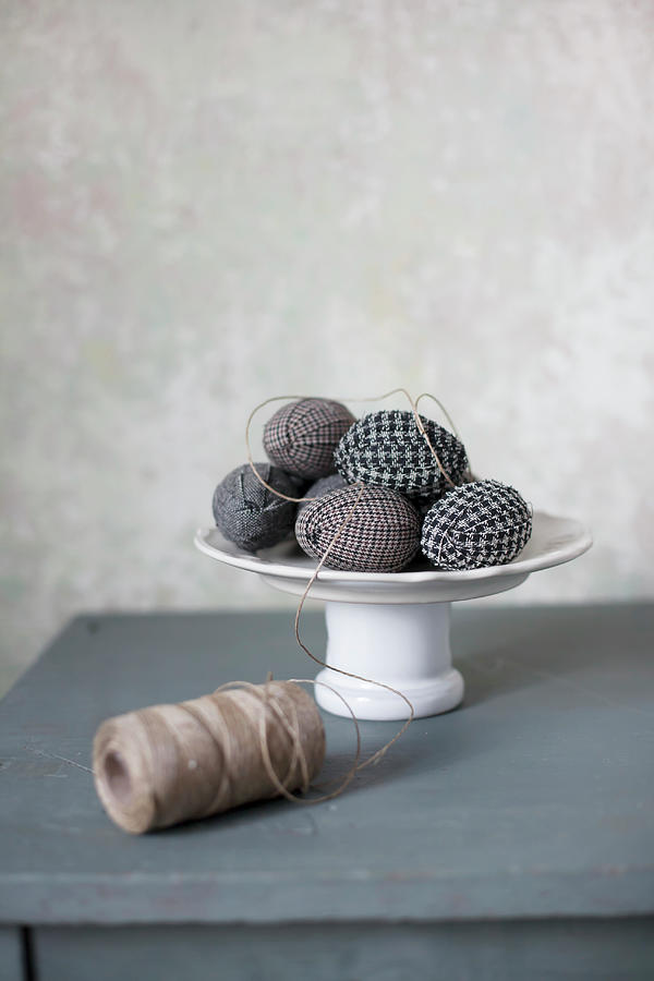 Easter Eggs Wrapped In Fabric On Cake Stand And Reel Of Twine Photograph by Alicja Koll