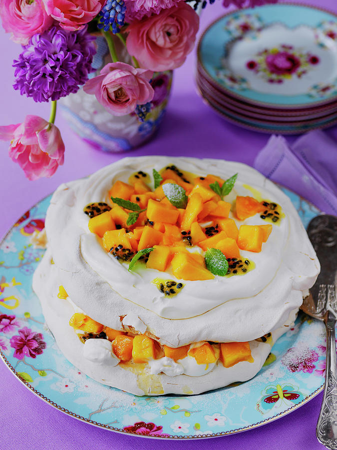 Easter Mango And Passion Fruit Pavlova With Mint Leaves With Vase Of Sporing Flowers Photograph by Michael Paul