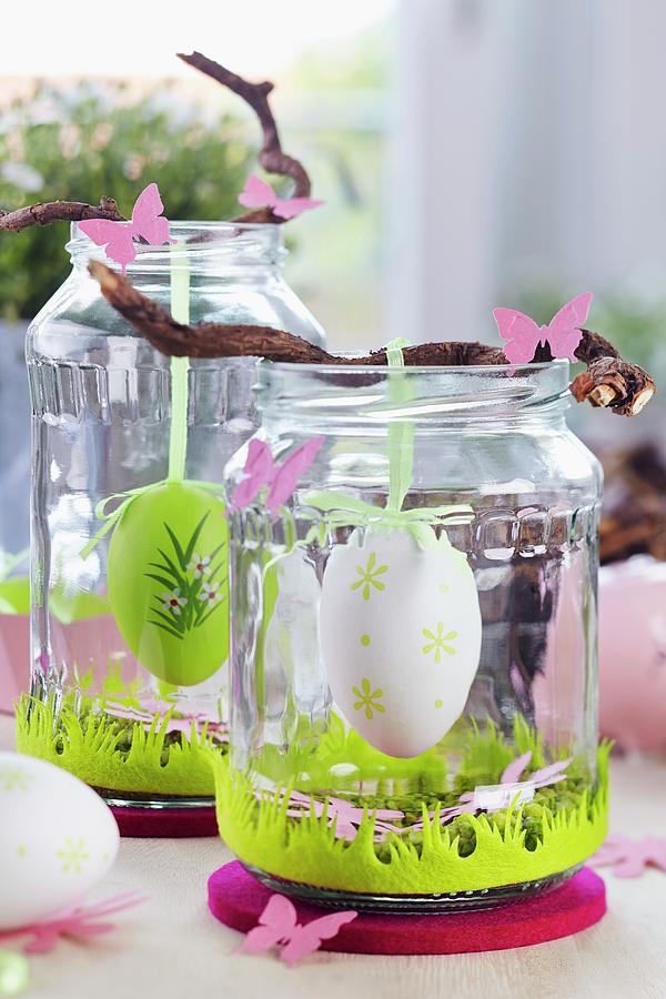 Easter Table Decorations With Easter Eggs Hanging From Twigs In Screw-top Jars Photograph by Franziska Taube