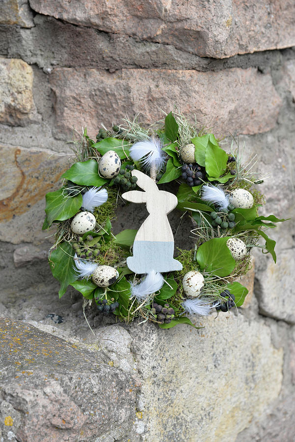 Easter Wreath Wrapped From Moss, Hay, And Ivy, Decorated With Quail Eggs, Chicken Feathers, And A Wooden Bunny Figure Photograph by Daniela Behr