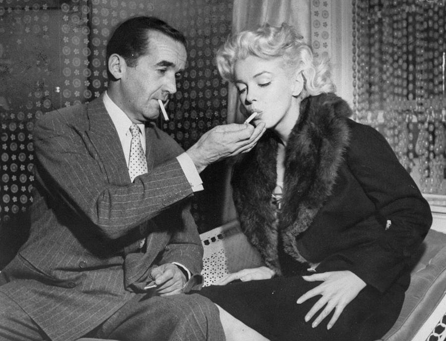 Edward R. Murrow Lights Cigarette For Photograph by New York Daily News Archive