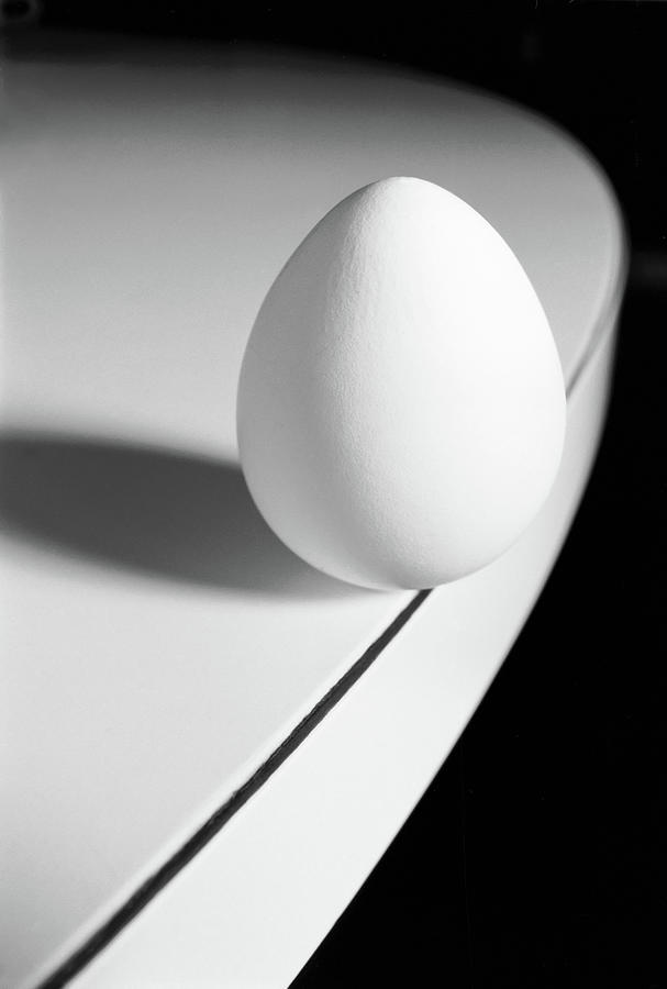 Egg Carefully Balancing At The Edge Of Photograph by Scotspencer