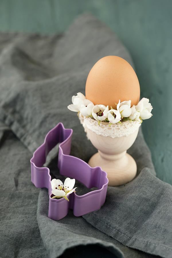 Egg Cup Decorated With Pear Blossom Next To Bunny-shaped Pastry Cutter Photograph by Mandy Reschke