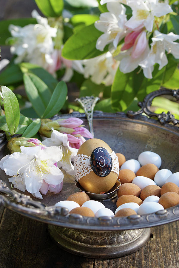 Egg With Tip In A Silver Bowl With Rhododendron Flowers And Marzipan Eggs Photograph by Angelica Linnhoff