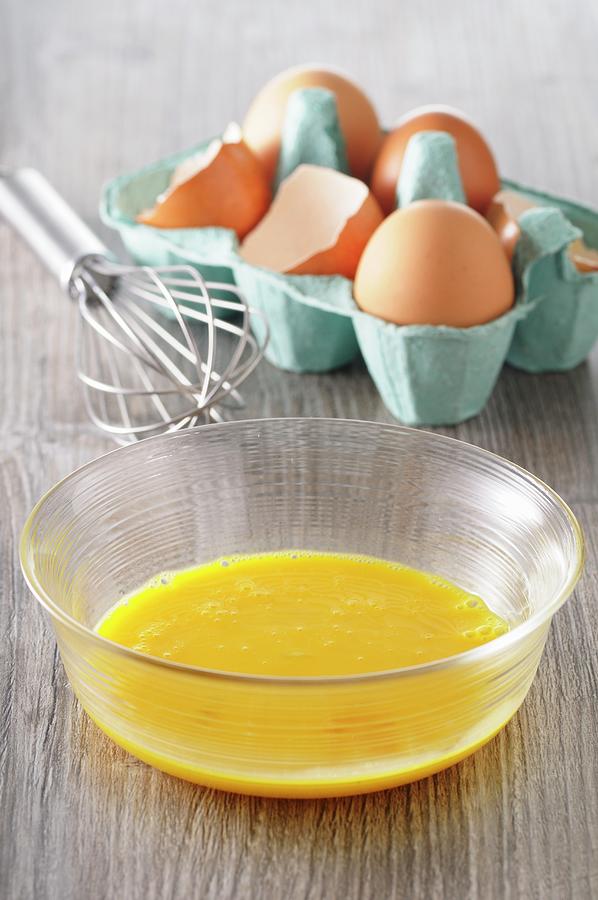 Egg Yolks In A Bowl, Eggs In An Egg Box And A Whisk Photograph by Jean-christophe Riou