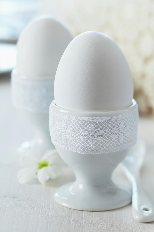 Eggcups Trimmed With White Lace Ribbon As Romantic Decorations On Breakfast Table Photograph by Franziska Taube
