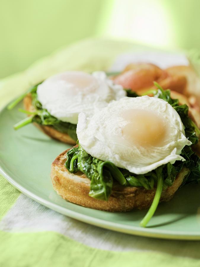 Eggs Benedict On Toasted Bread With Spinach Leaves Photograph by Jim Scherer