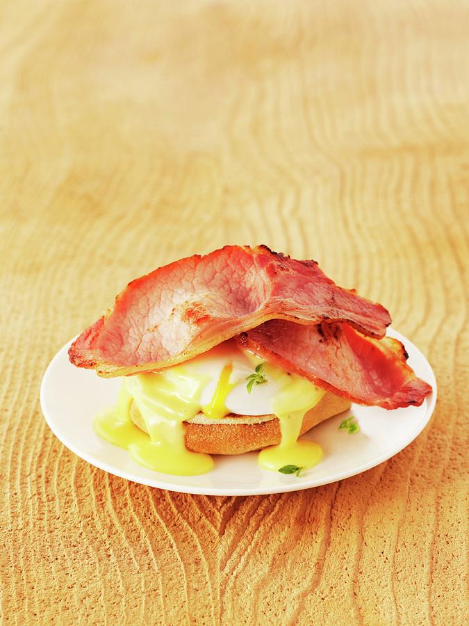 Eggs Benedict toast Topped With A Poached Egg, Bacon And Hollandaise Sauce Photograph by Frank Adam