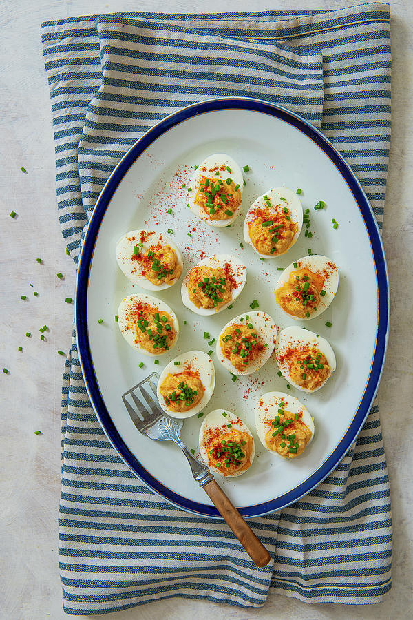 Eggs Stuffed With Spiced Egg Yolks, Paprika And Chives Photograph by ...