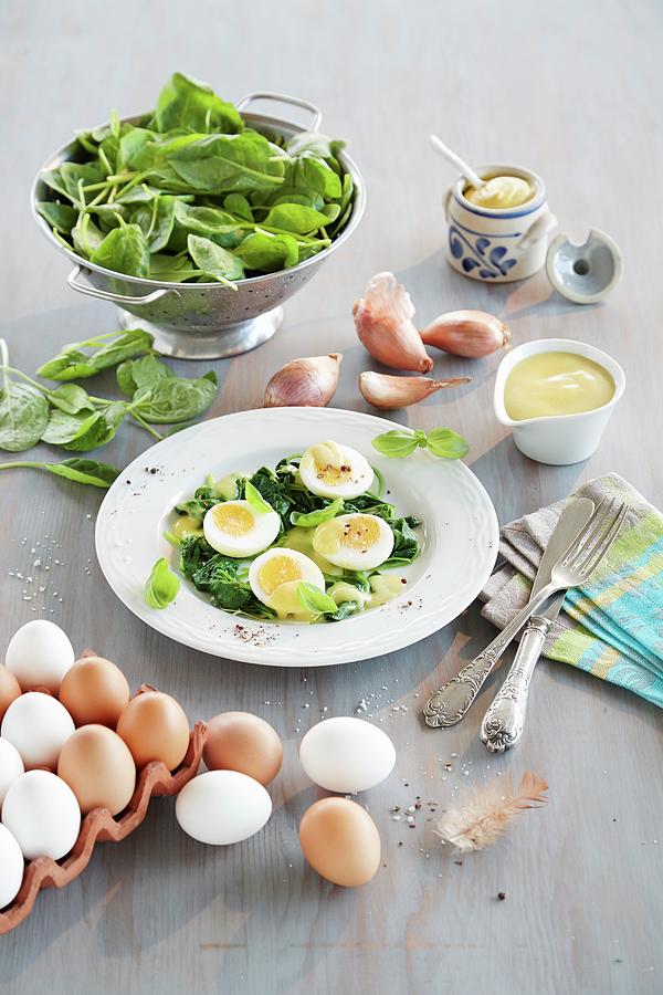 Eggs With Mustard Sauce And Baby Leaf Spinach Photograph by Rafael Pranschke