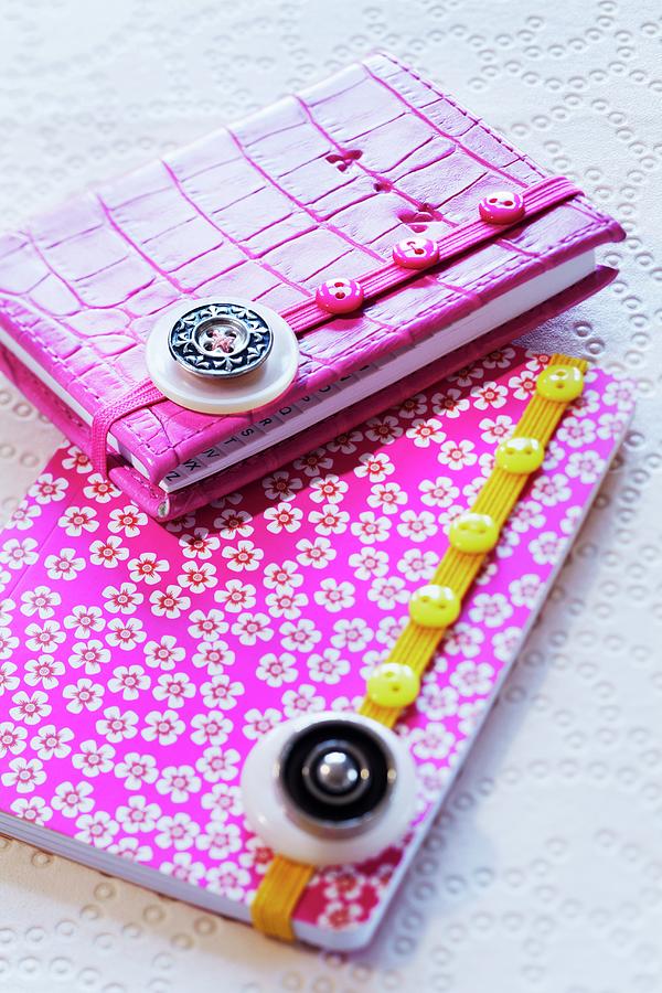 Elastic Ribbons Decorated With Buttons On Notebooks Photograph by Franziska Taube