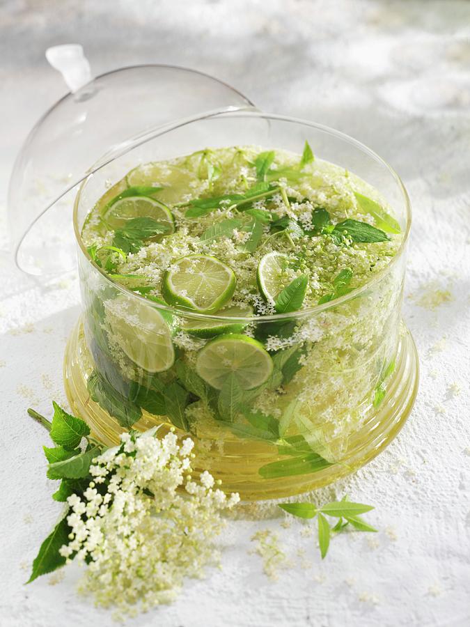 Elderflower Cordial With Herbs And Lime Photograph by Karl Newedel