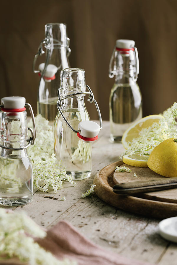 Elderflower Syrup In Flip-top Glass Bottles Photograph by Jennifer Braun