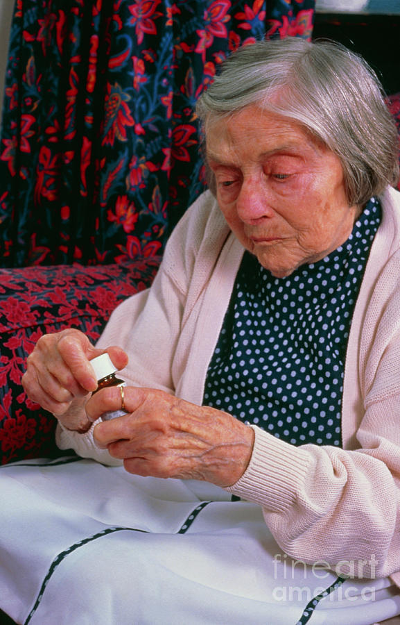 Elderly Woman With Bottle Of Tablets Photograph by Mark Clarke/science Photo Library