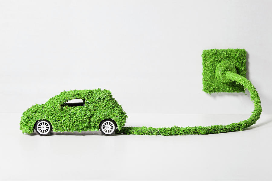 Electric Car Covered With Grass Photograph by Westend61