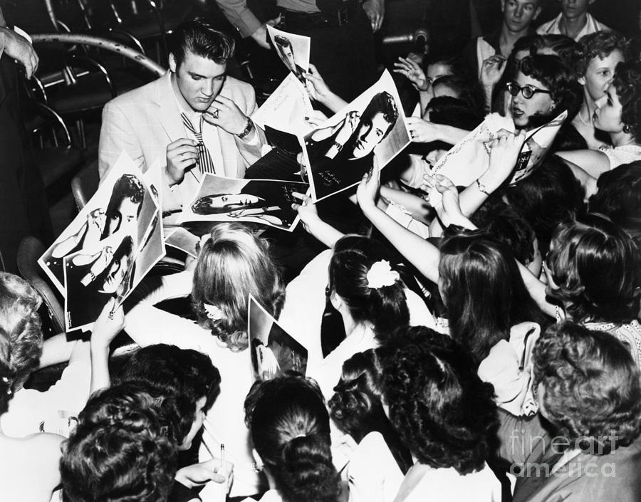 Elvis Presley Signing Autographs Photograph by Bettmann