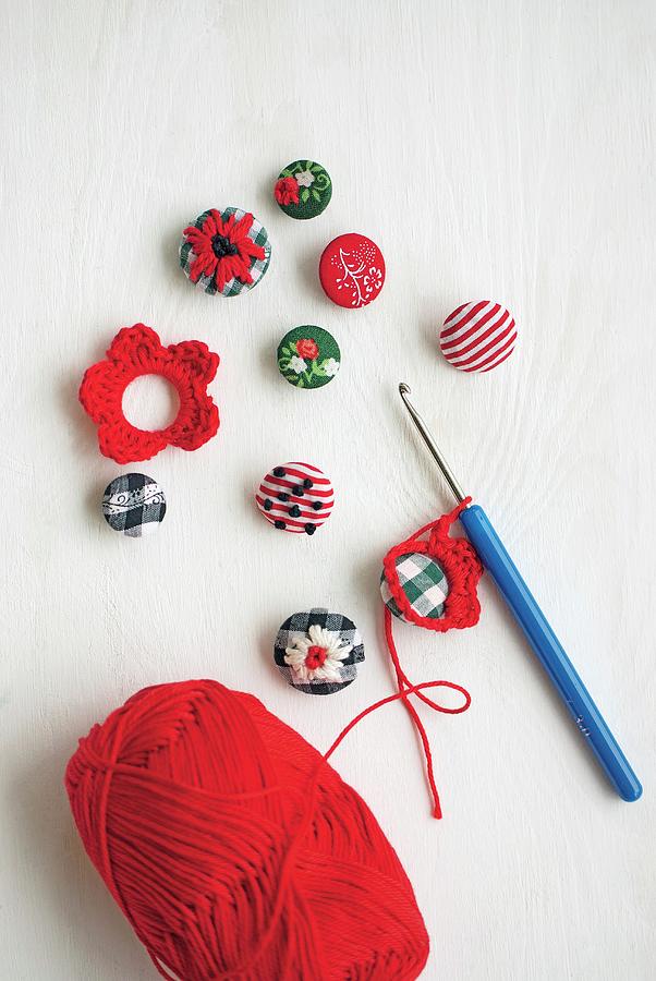Embroidered Buttons With Crocheted Flower Motifs, Crochet Hook And Ball Of Red Wool Photograph by Patsy&christian