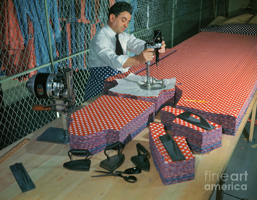 Employee Working With Fabric Cutter Photograph by Bettmann