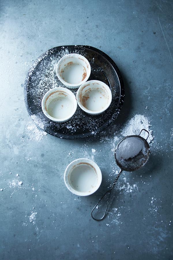 Empty Baking Tins And A Sieve Of Icing Sugar Photograph by Joerg Lehmann