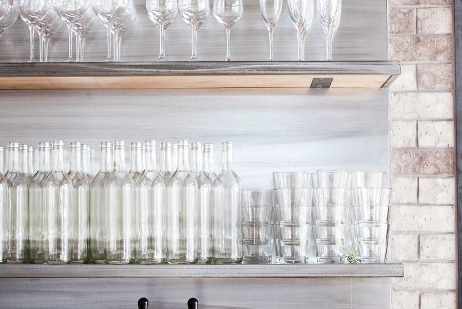 Empty Bottles And Glasses On Shelves Photograph by Jennifer Martine