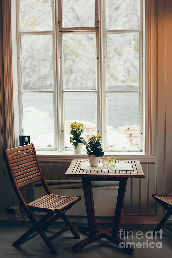 Empty table and antique wooden chairs near a window Photograph by Joaquin Corbalan