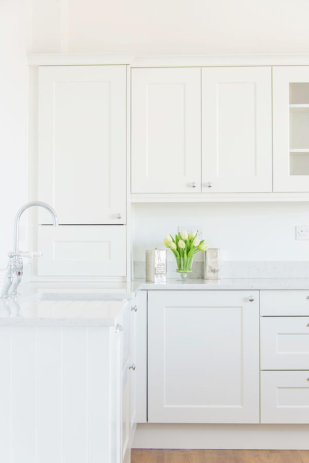 Empty White Kitchen With Panelled Cabinet Doors Photograph by Stuart Cox