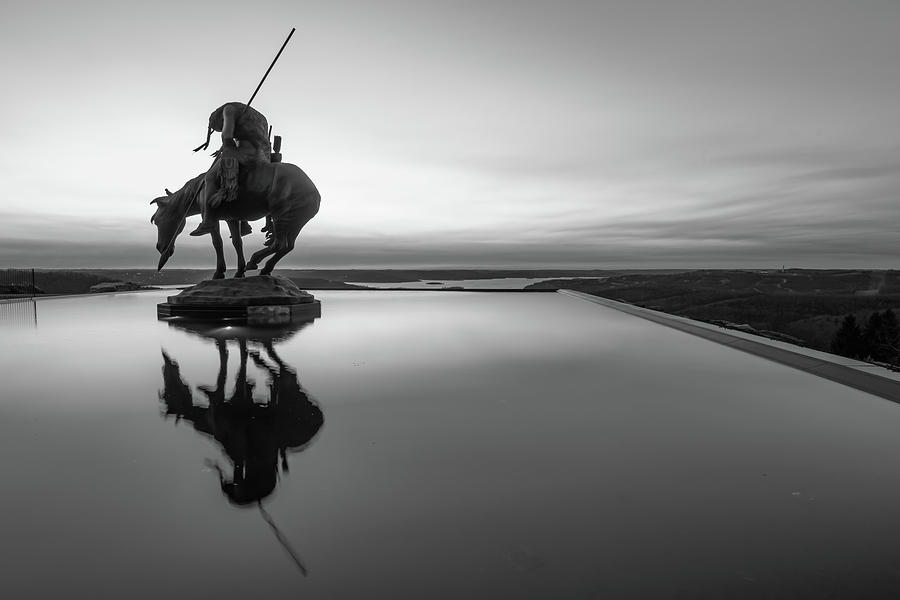 Still Life Photograph - End of the Trail Statue Silhouette - Top of the Rock Sunset Reflections in Black and White by Gregory Ballos