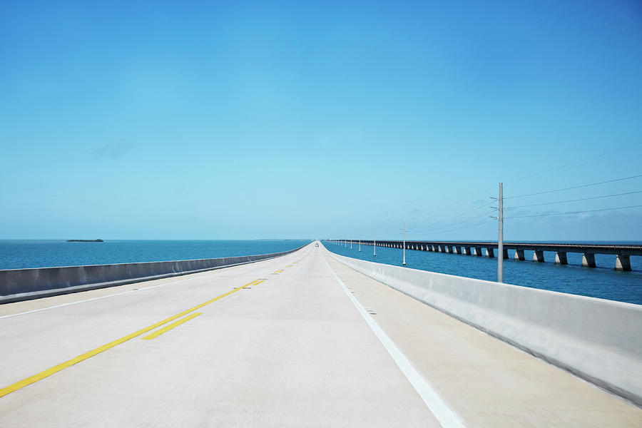 Endless Straight Road Over The Ocean Photograph by Ideeone