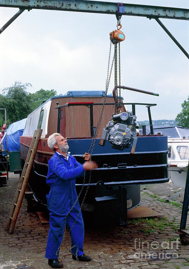 Engineer Using Block & Tackle To Lift Boat Engine Photograph by Adam Hart-davis/science Photo Library