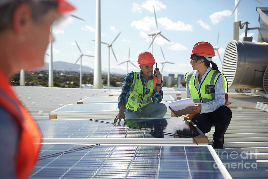 Engineers Examining Solar Panels Photograph by Caia Image/science Photo
