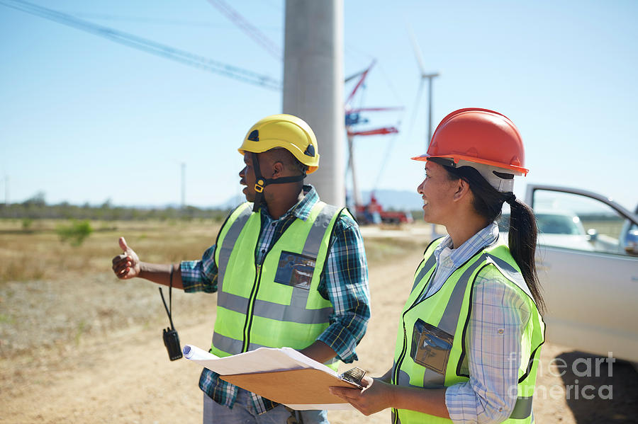 African Photograph - Engineers With Blueprints Talking At Sunny Power Plant by Caia Image/science Photo Library African Photograph - Engineers With Blueprints Talking At Sunny Power Plant by Caia Image/science Photo Library