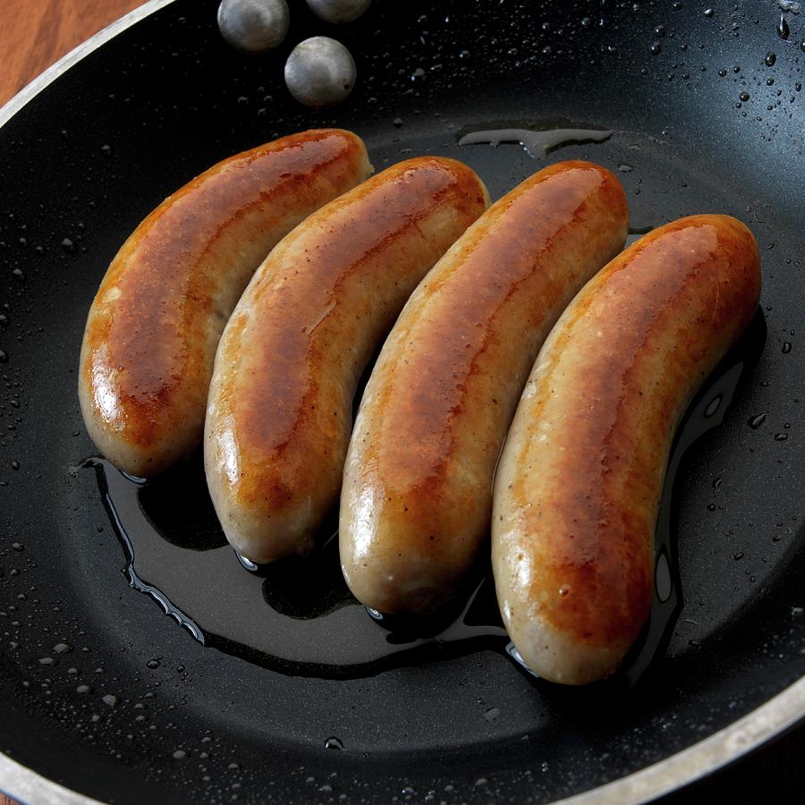 English Bangers breakfast Sausages In Skillet Photograph by Paul Poplis