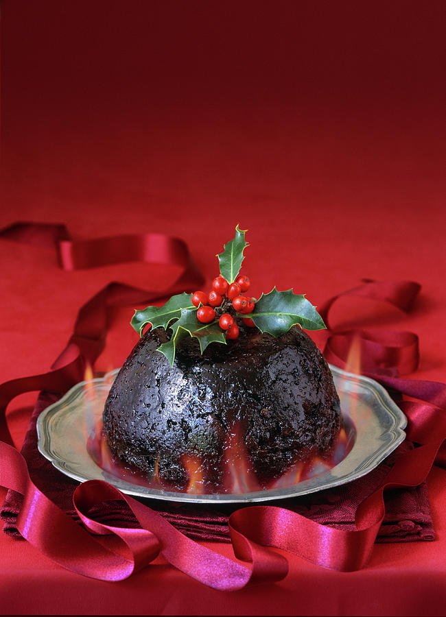 English Christmas Pudding With Flames And Holly Garnish On Pewter Plate Photograph by Michael Paul