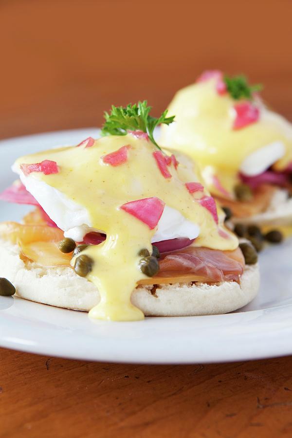 English Muffins Topped With Poached Eggs, Caramelised Onions, Smoked Salmon, Capers And Hollandaise Sauce Photograph by Amy Kalyn Sims