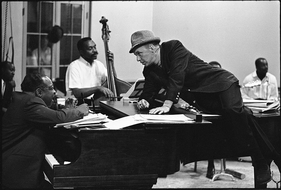 Entertainer Frank Sinatra (R) leaning across piano chatting with Count Basie during rehearsal for upcoming Vegas show. Photograph by John Dominis